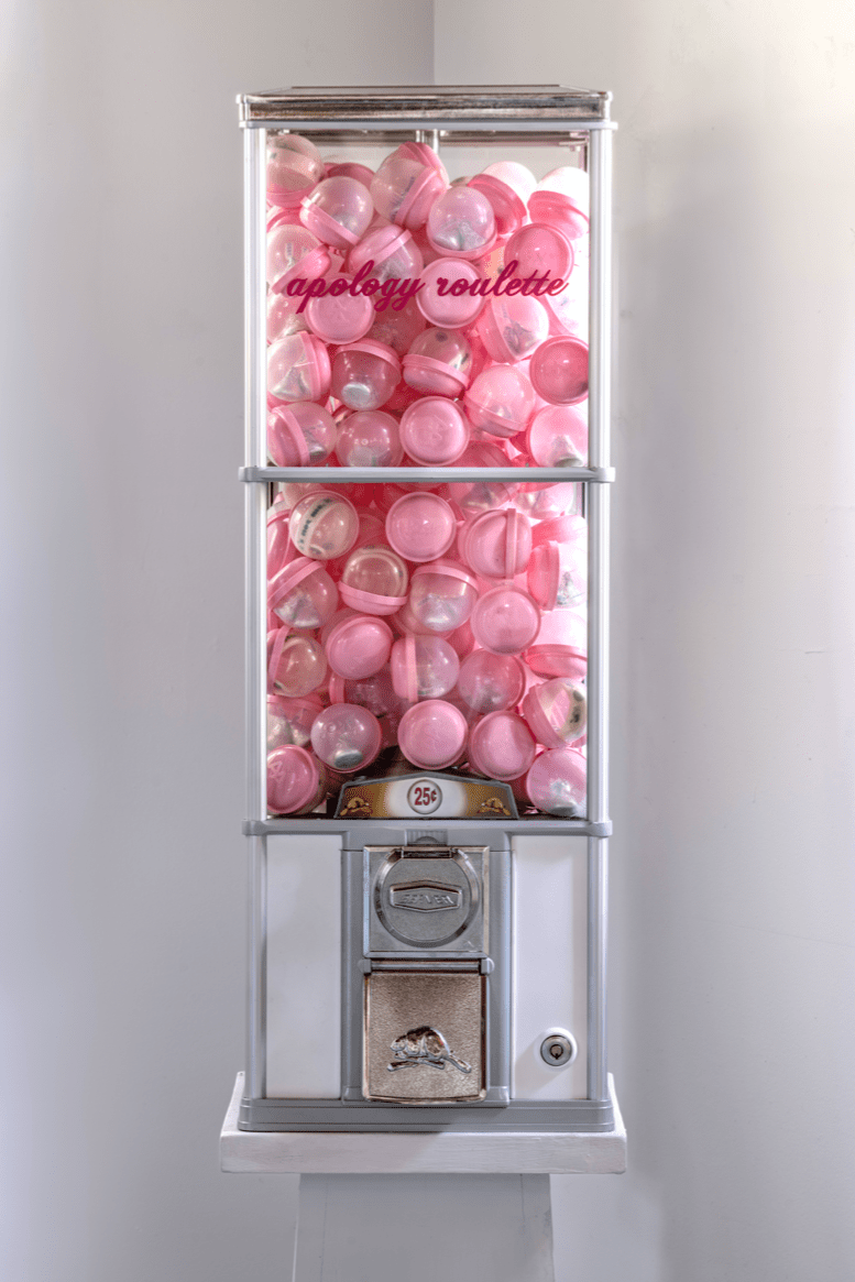 gumball machine filled with pink and clear plastic bubbles