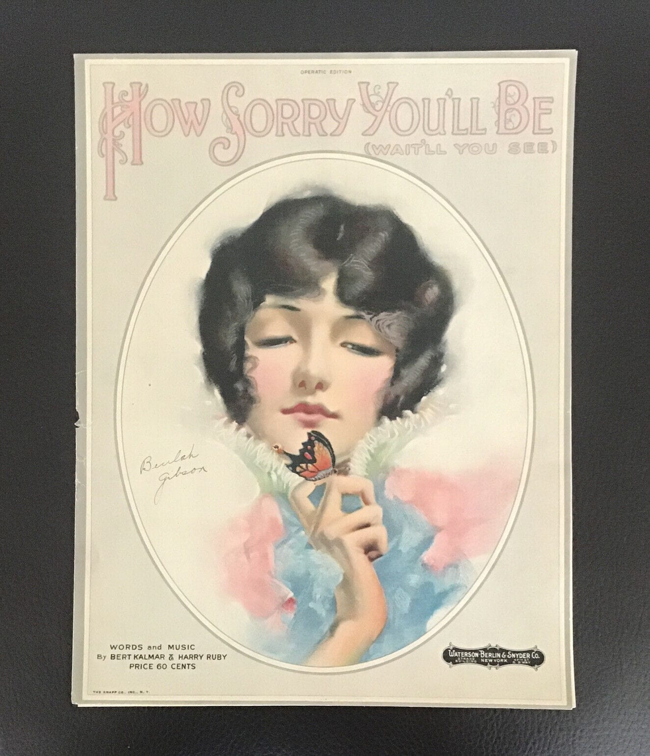 A vintage illustration on the cover of a piece of sheet music depicts a woman with bobbed hair and half-closed eyes studying a butterfly on her finger. Her expression is unreadable. 