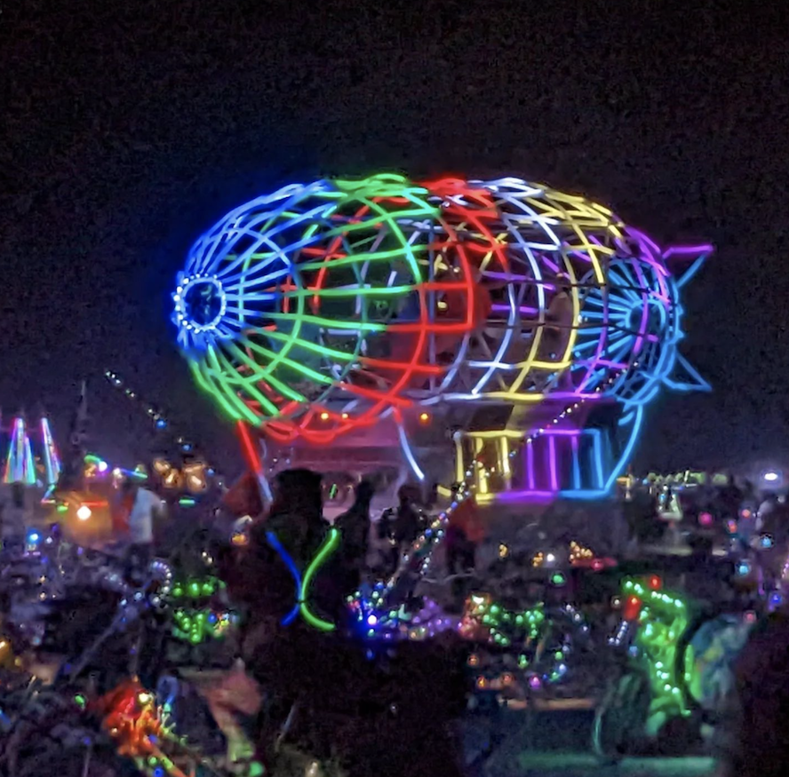L.E.D. Zeppelin art car at night, all lit up, at Burning Man