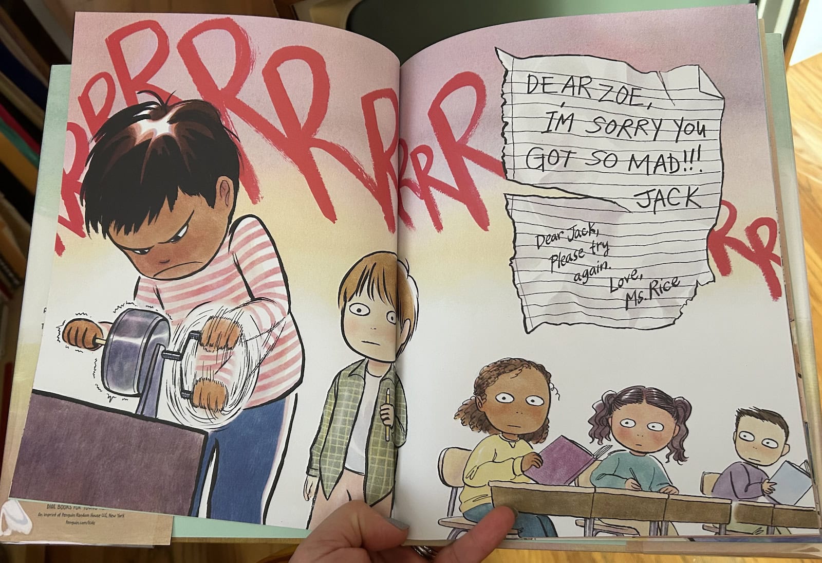 spread from the picture book I'm Sorry You Got Mad showing a little boy in a striped shirt furiously sharpening a pencil so the sound RRRRRRRRRRR covers half the spread, while the boys classmates look on in some alarm